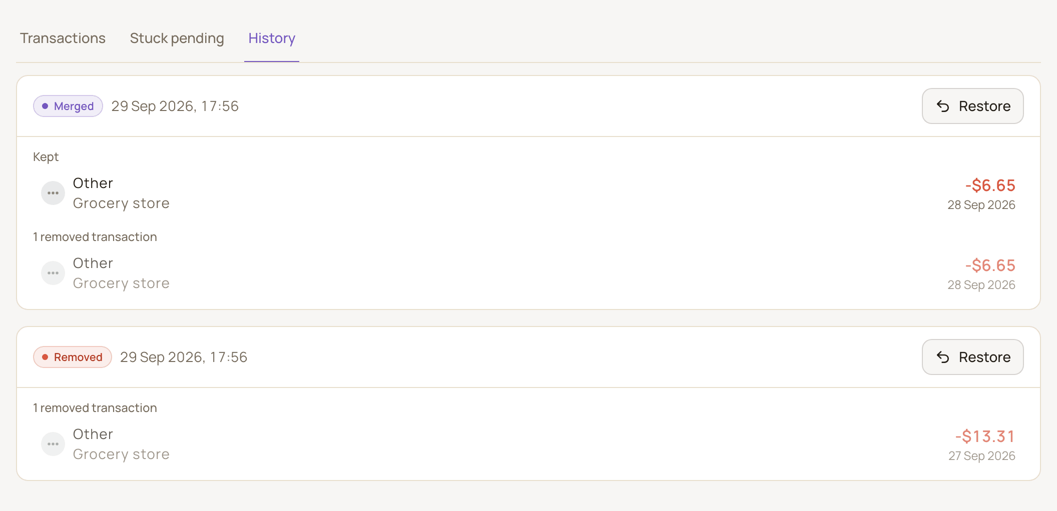 The History tab with a Merged entry showing the kept transaction and the removed one, and a Removed entry below it, each with a Restore button.